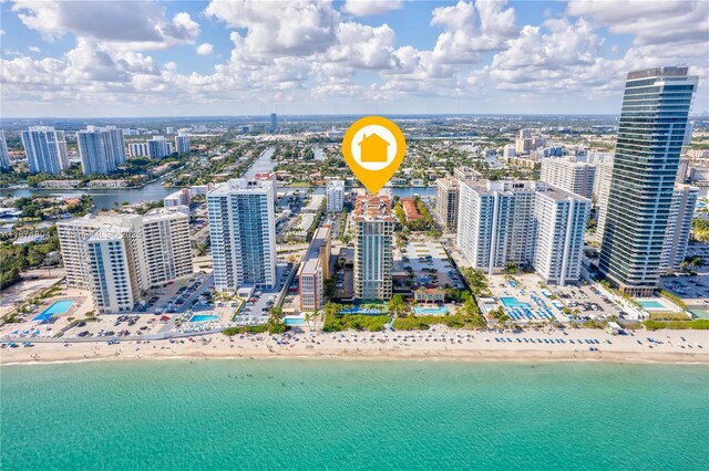 aerial view with a water view and a view of the beach