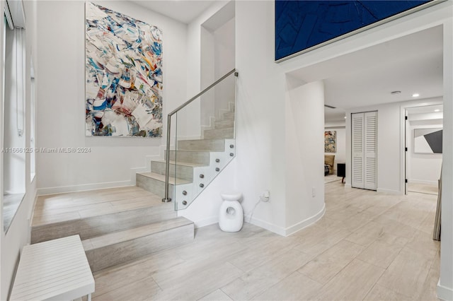 stairway with hardwood / wood-style floors