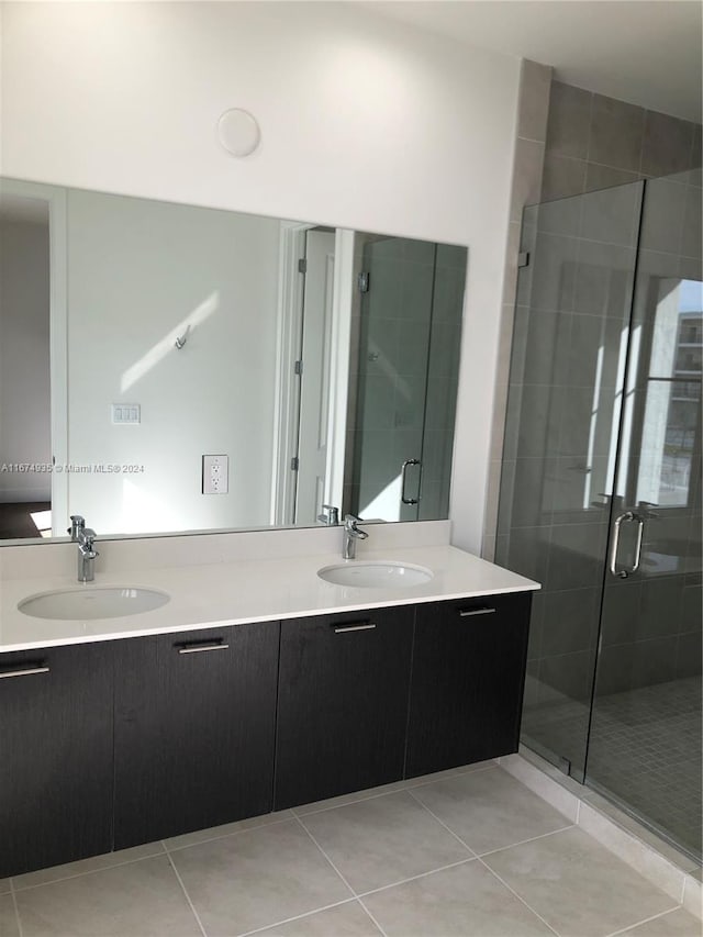 bathroom with vanity, an enclosed shower, and tile patterned floors