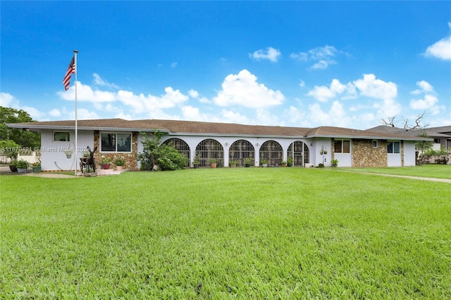 ranch-style home featuring a front yard