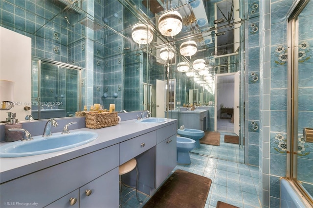 full bathroom with toilet, tile patterned flooring, a bidet, vanity, and tile walls