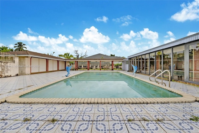 view of swimming pool with a patio