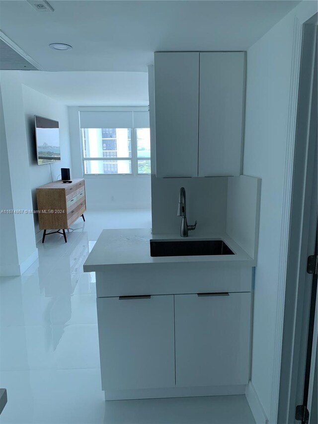 kitchen featuring light stone countertops and sink