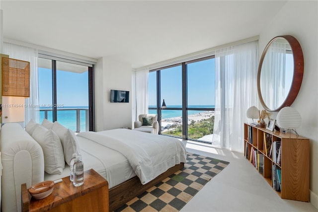 bedroom featuring access to outside and floor to ceiling windows