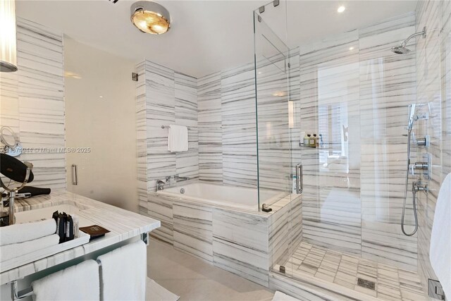 bathroom with vanity and independent shower and bath