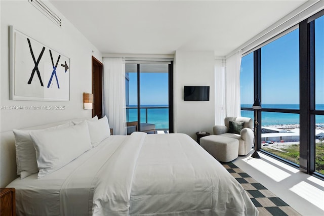 bedroom with access to outside and expansive windows