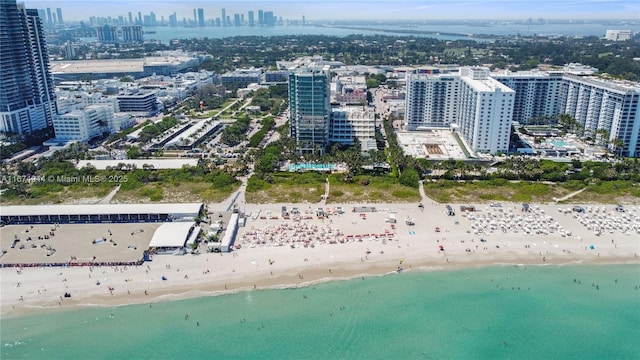 birds eye view of property featuring a view of the beach and a water view