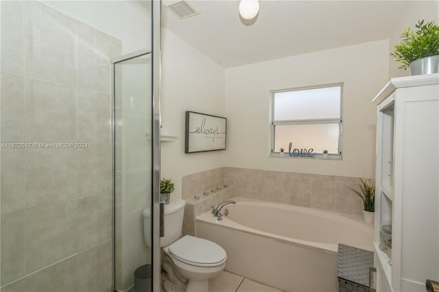 bathroom with tile patterned floors, a washtub, a textured ceiling, and toilet