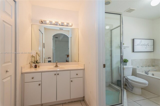 full bathroom featuring tile patterned flooring, vanity, toilet, and shower with separate bathtub