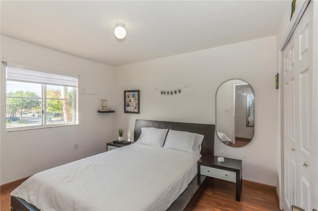 bedroom featuring a closet and dark hardwood / wood-style floors