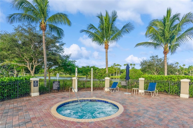 view of swimming pool with a patio area and a hot tub