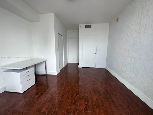 empty room featuring dark wood-type flooring