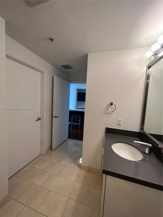 bathroom featuring tile patterned flooring and vanity