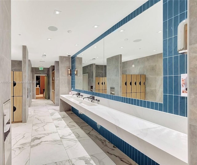 bathroom with vanity and tile walls