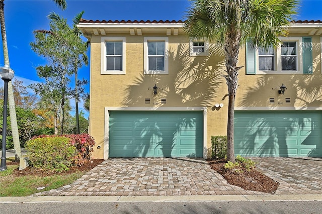 mediterranean / spanish-style house with a garage