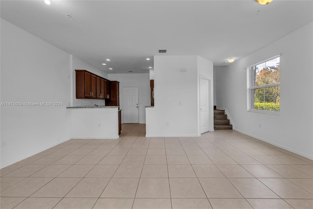 unfurnished living room featuring light tile patterned flooring