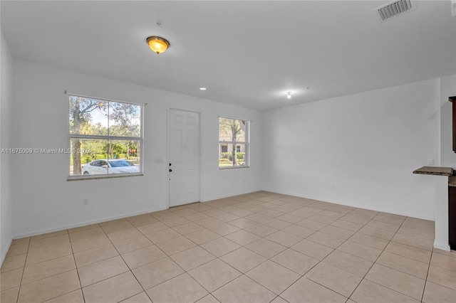 tiled empty room with plenty of natural light