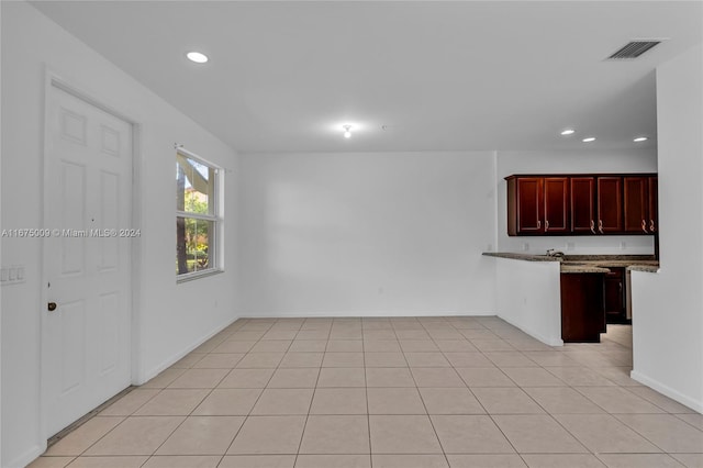 spare room featuring light tile patterned flooring