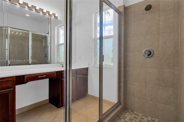 bathroom featuring tile patterned floors, vanity, and a shower with shower door