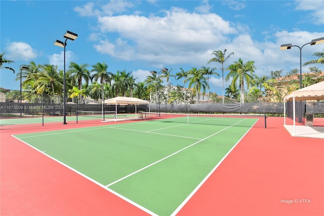 view of tennis court featuring basketball hoop