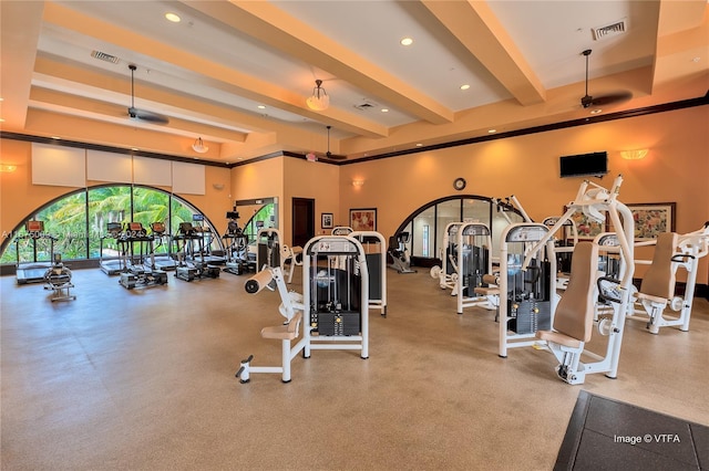 exercise room featuring a high ceiling and ceiling fan