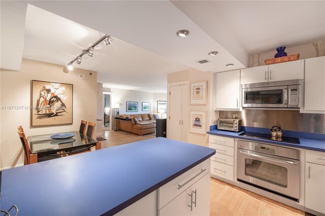 kitchen featuring kitchen peninsula, light hardwood / wood-style flooring, white cabinets, and rail lighting