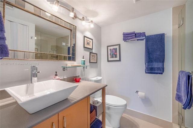 bathroom featuring vanity and toilet