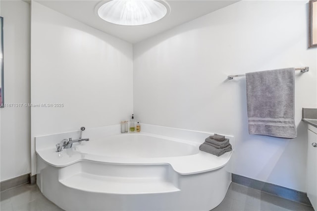 bathroom featuring a washtub and vanity