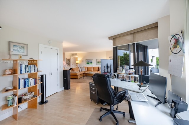 office area with light hardwood / wood-style floors