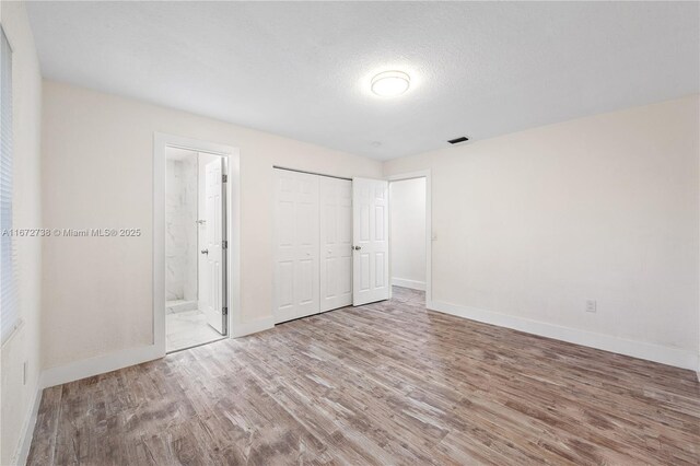 bedroom featuring a closet and light hardwood / wood-style floors