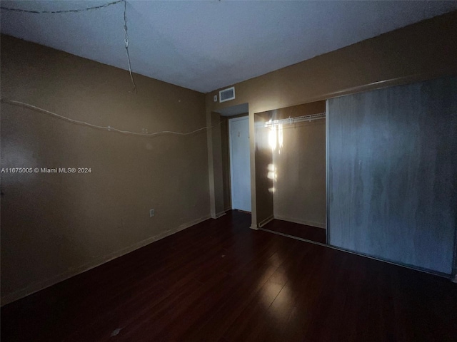 interior space with a closet and dark wood-type flooring