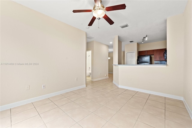 tiled spare room with ceiling fan