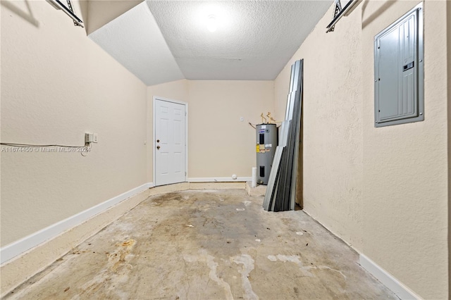 garage featuring electric panel and electric water heater