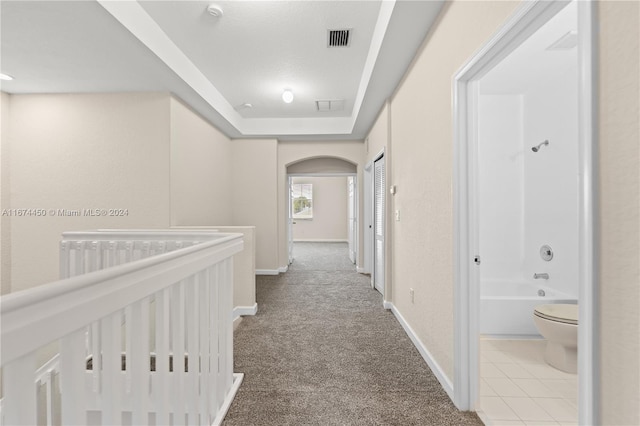 corridor with light colored carpet