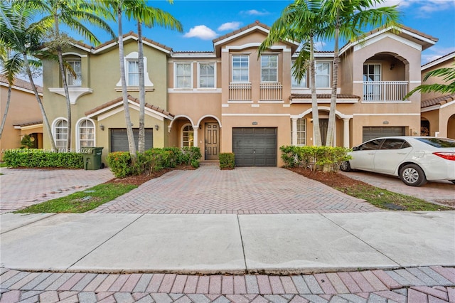 view of front of house with a garage and a balcony