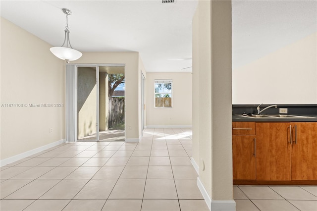 tiled dining room featuring sink