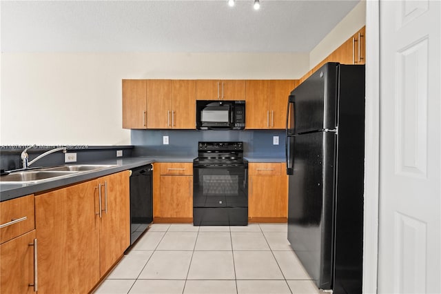 kitchen with light tile patterned floors, a textured ceiling, sink, and black appliances