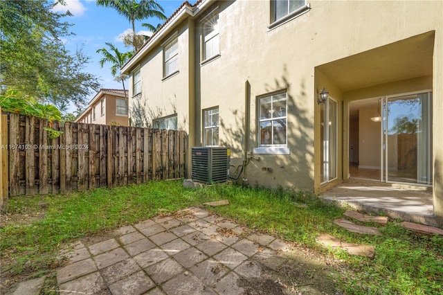 exterior space with central AC and a patio