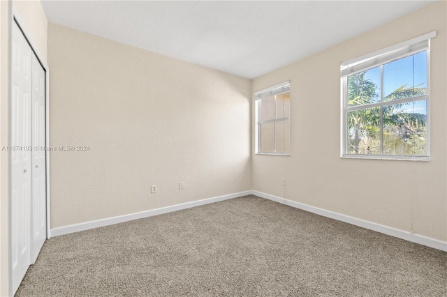 unfurnished bedroom featuring a closet and carpet flooring