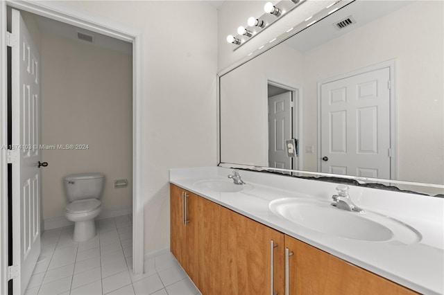 bathroom with vanity, tile patterned flooring, and toilet