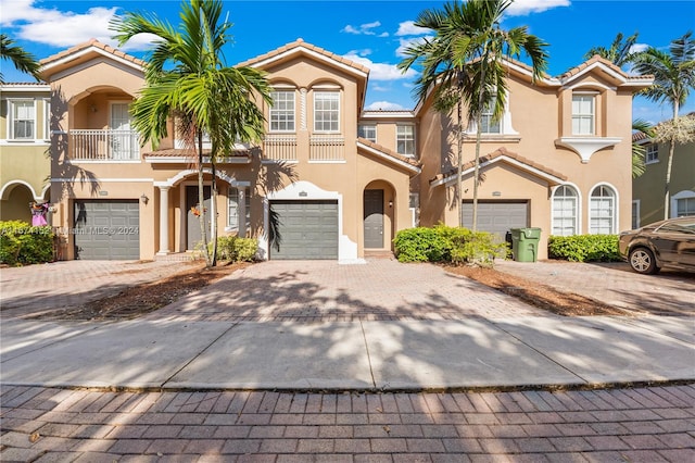 view of front of home featuring a balcony and a garage