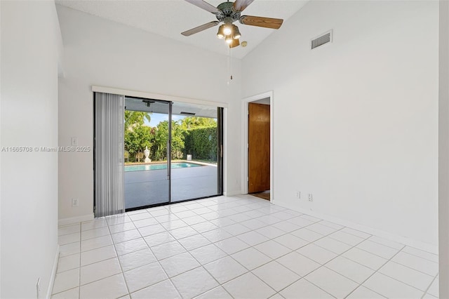 spare room featuring light tile patterned floors, high vaulted ceiling, and ceiling fan