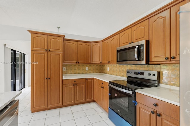 kitchen with decorative backsplash, light tile patterned flooring, and stainless steel appliances