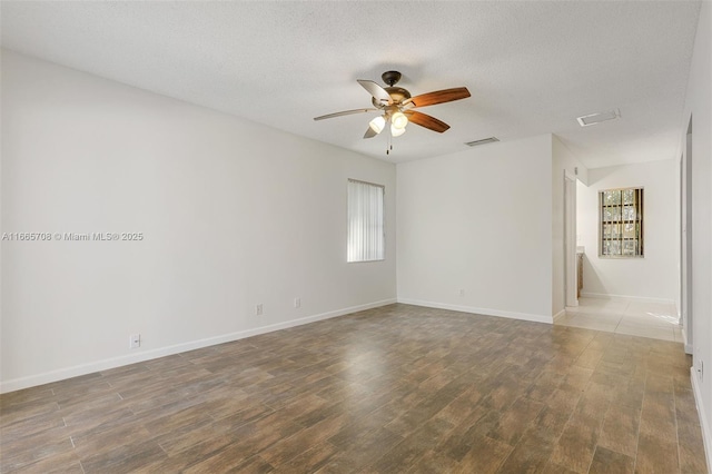 spare room with hardwood / wood-style floors, a textured ceiling, and ceiling fan