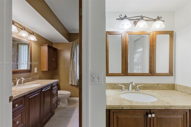 bathroom featuring toilet, vanity, and tile patterned floors