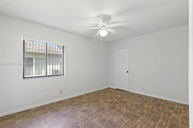 empty room with a textured ceiling and ceiling fan