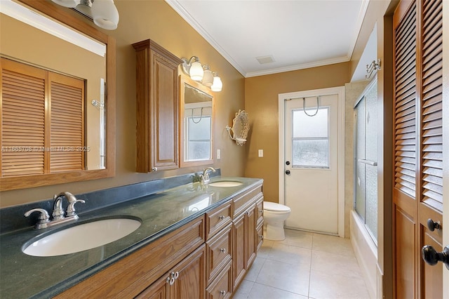 full bathroom featuring vanity, tile patterned floors, crown molding, toilet, and enclosed tub / shower combo