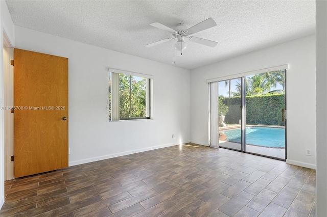 unfurnished room featuring ceiling fan, plenty of natural light, and a textured ceiling