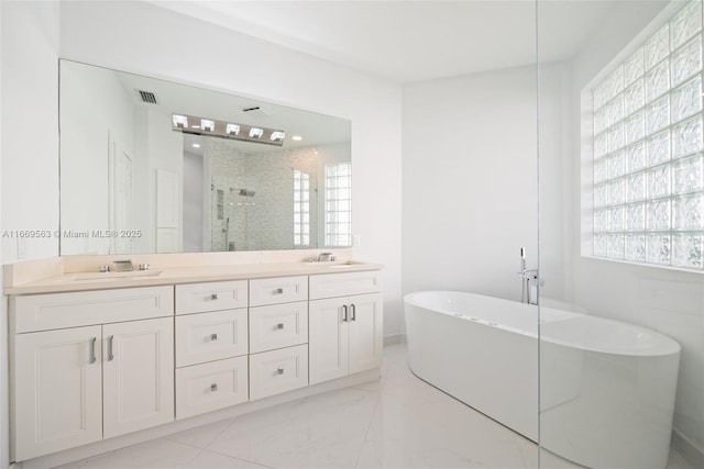 bathroom featuring plus walk in shower and vanity