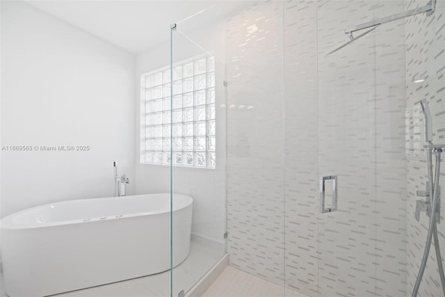 bathroom featuring tile patterned floors, plenty of natural light, and independent shower and bath